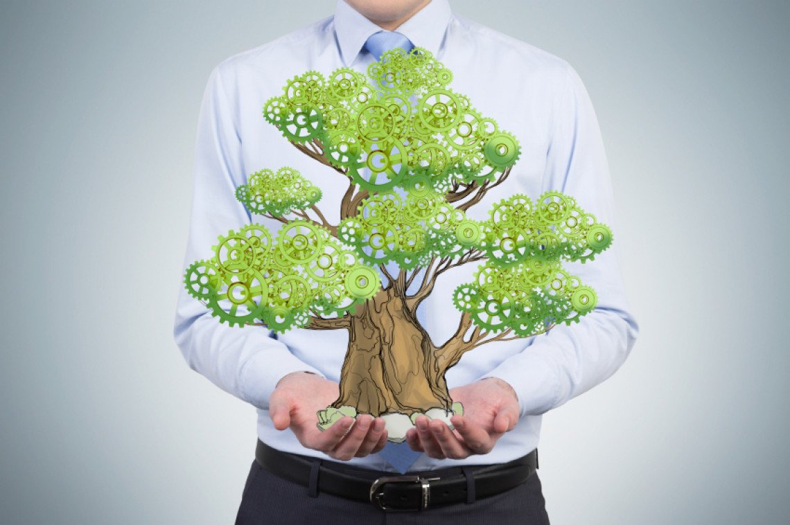 A person in formal clothes holds a sketched tree on the palms. Light blue background. A concept of the process of a growing business or a start up.